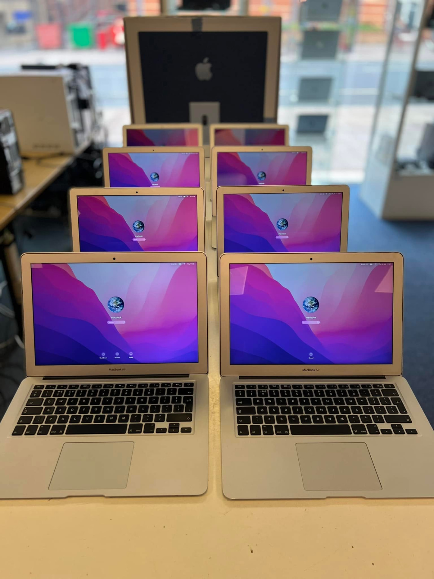 Rows of MacBook Air laptops powered on at Titan Computers in Exeter