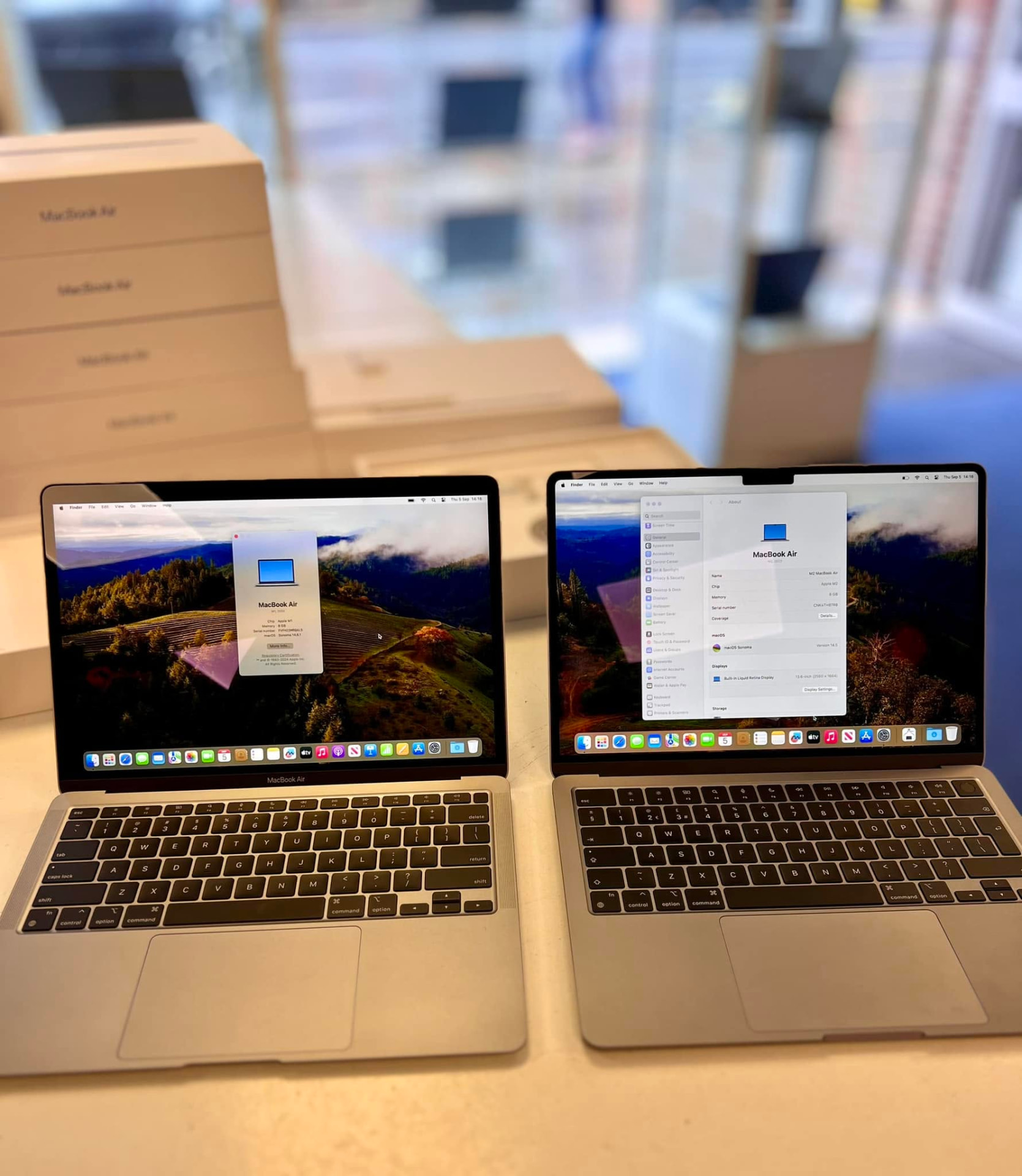 Two MacBook Air laptops displaying their system information at Titan Computers
